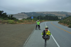Rod takes a break on the climb south of Tunitas Creek while Zach looks back to check on him.