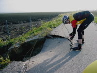 Randall sets some sticks to mark a new sinkhole on the Castroville bike path.