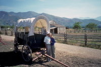 David and Kay in front of a conestoga at the Mormon 