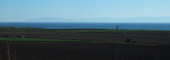 Salinas Valley, Mt. Toro, and the Santa Lucia Mountains can be seen on the south side of Monterey Bay from CA1 west of Santa Cruz.