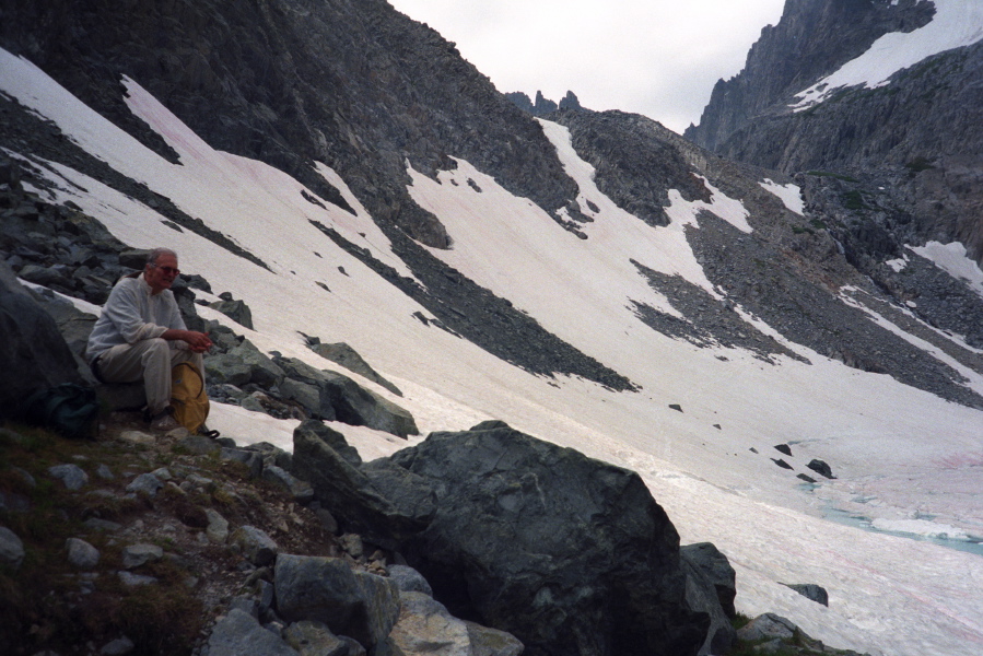 The trail to Cecile Lake climbs across the snowfield and up the headwall in the background.