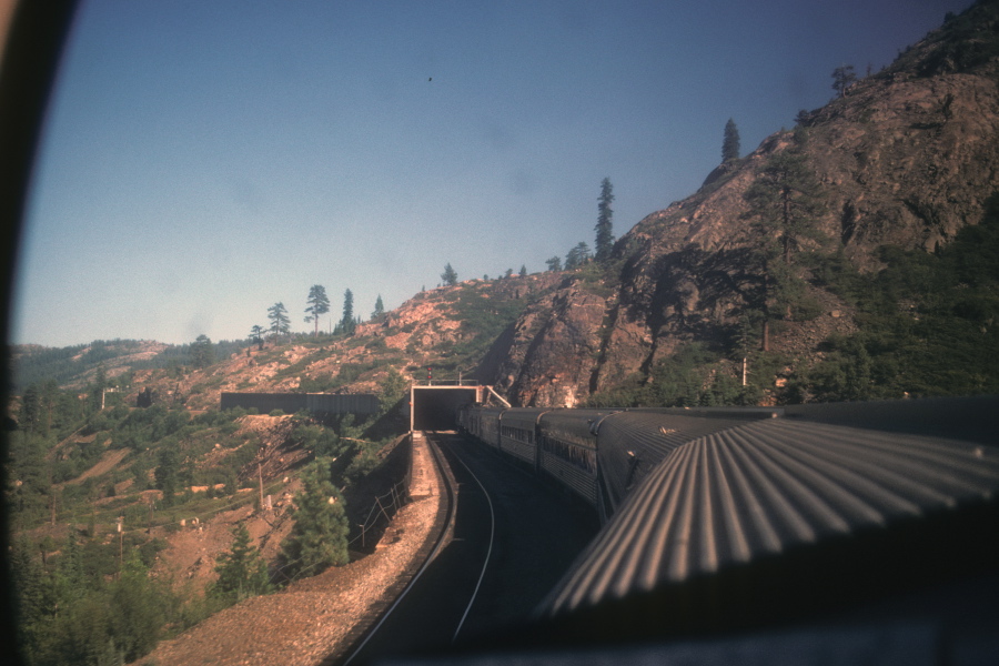 The train goes through a snow shed.