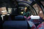 Children enjoy looking out the window of the dome car.