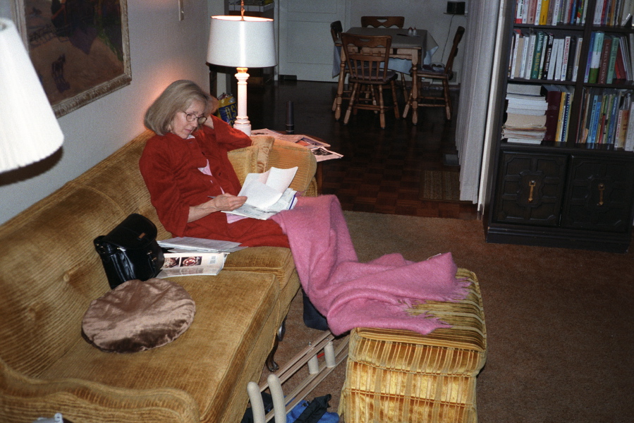 Kay rests on the couch after dinner.