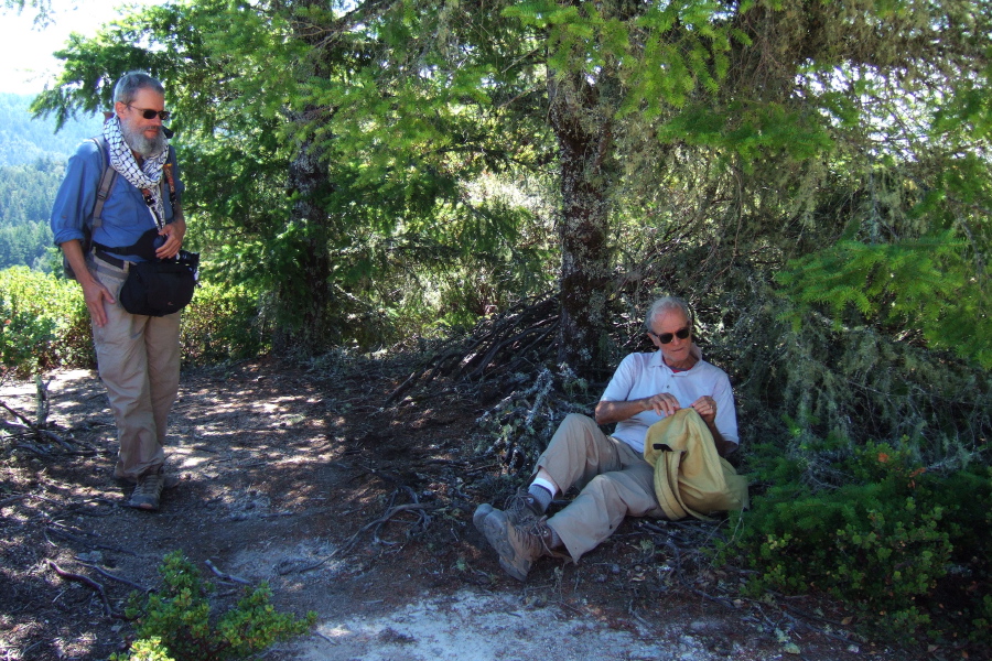 David finishes up lunch in one of the few shady spots on Chalk Mountain while Frank looks on.