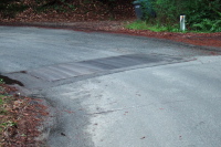 This metal plate is at the apex of a sharp corner on the intermediate downhill on the climb up Upper Zayante Rd.  Bicyclists beware!