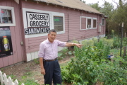 John, the proprietor, shows me his vegetable garden behind the store.