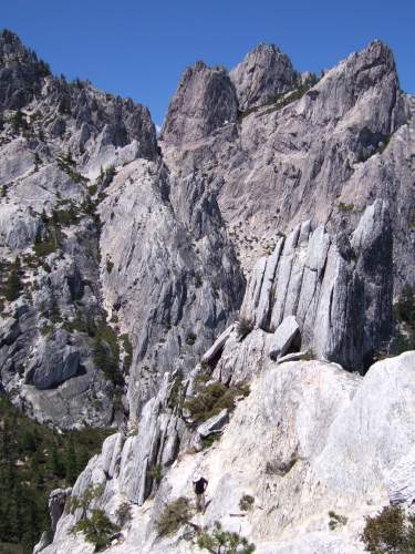 David scrambles his way down the crag.