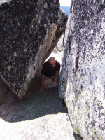 David crawls under the rock to the hidden ledge.