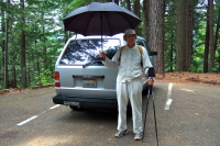 Dad is prepared for any weather with his enormous umbrella.