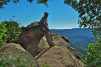 David rests against a sculpted rock and enjoys the view.