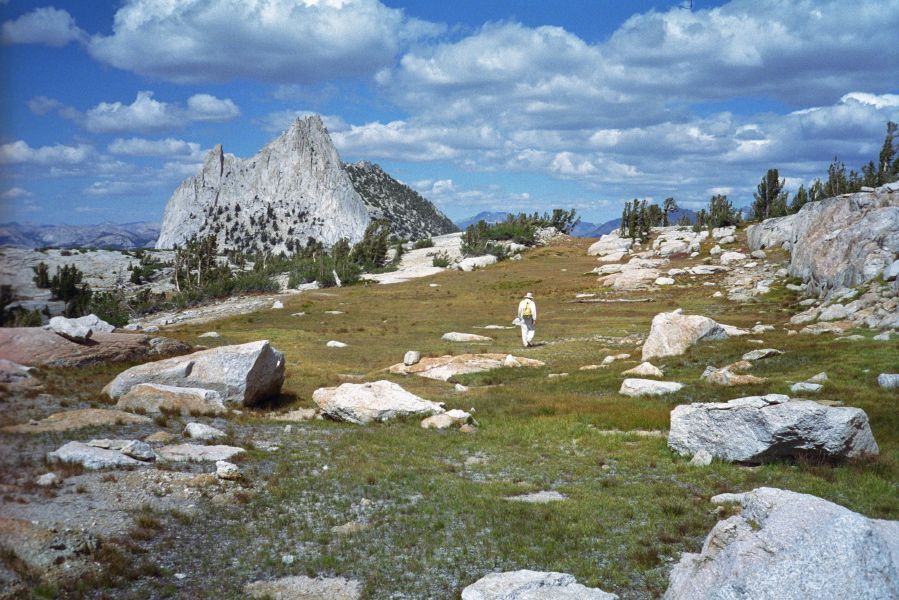 David walks up one of the broad terraces toward Cathedral Peak.