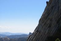Climber on the southeast buttress of Cathedral Peak; Columbia Finger (10360ft) in the background.