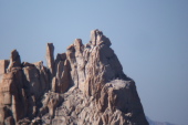 A climber reaches the top of Cathedral Peak.