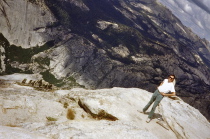 Bill on the edge; view is into Tenaya Canyon.