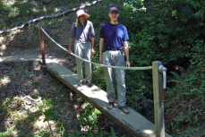 Steve and David cross the half log bridge on Toyon Trail.