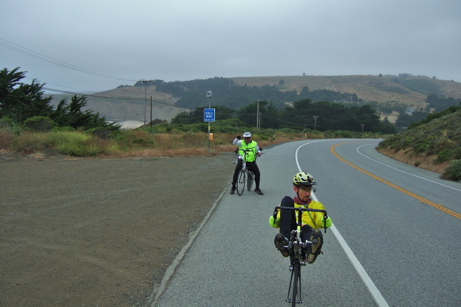 Rod takes a break on the climb south of Tunitas Creek while Zach looks back to check on him.