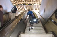 Bill struggles up the Rockridge BART stairway with his hybrid bike (80 lbs).