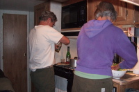 Ron and Alice prepare dinner, managing to work without getting in the other's way.