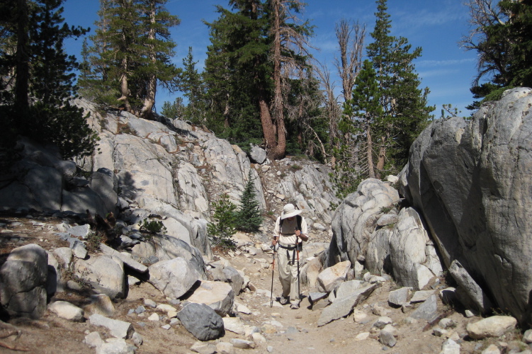 David hikes through a cleft in the granite on the Duck Pass trail.