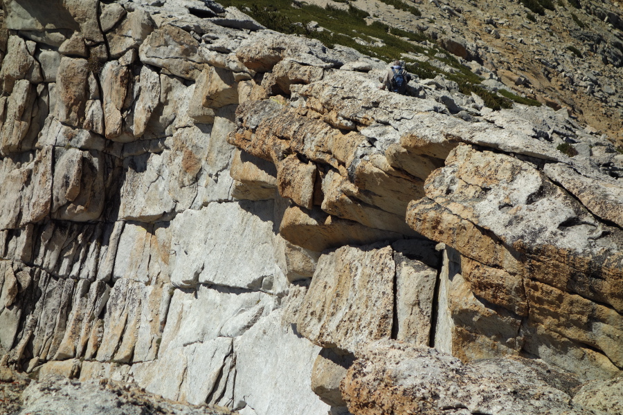 Frank sits on overhanging rock.