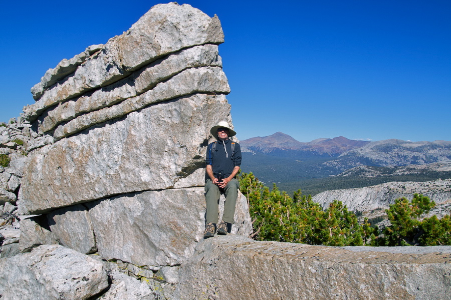 Bill sits on the granite wall.