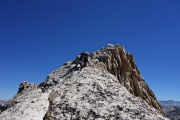 Frank climbs the arête to the summit.