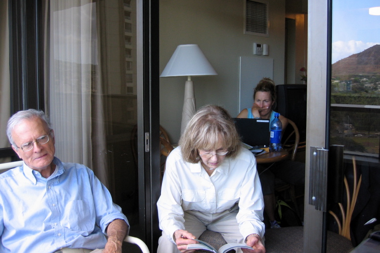 Dad relaxes, Mom reads about what to do, and Laura works on her computer.