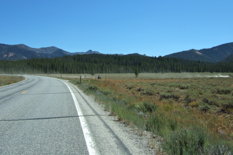 Off-road vehicles in the Salmon River Valley stir up dust.