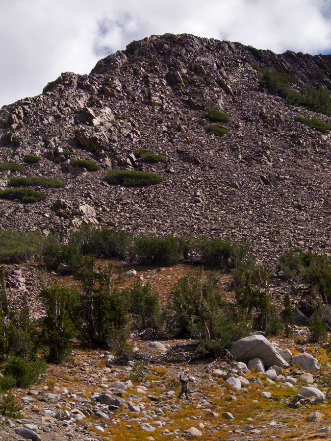 Bill reaches easier terrain below the peak.