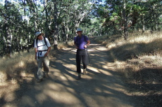 David and Bill P. walk back along the smooth and level road from Manzanita Group Campground.