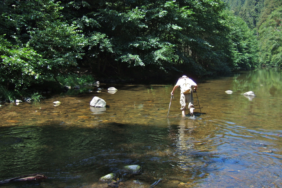 David crosses the main branch of the river to scout the route ahead.