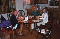 Laura, David, and Kay eat dinner in the condo.