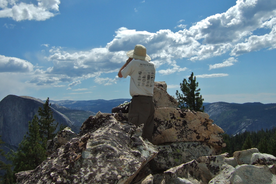 Bill watches climbers on Half Dome through binoculars.