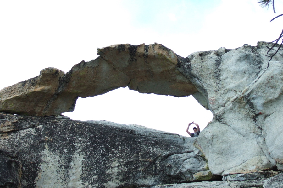 Another hiker takes a photo through Indian Arch.