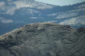 Half Dome hikers can be seen on Half Dome's sub-dome before the cables.