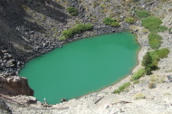 Green pool of water at the bottom one crater