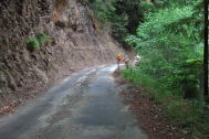 Gazos Creek Road narrows as it passes through a slide area.