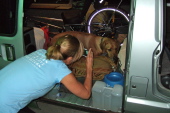 Laura says goodbye and photographs Kumba on his bed in the van