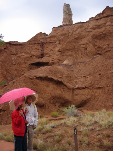 Kay and David in front of a sandstone feature with water running down its surface.