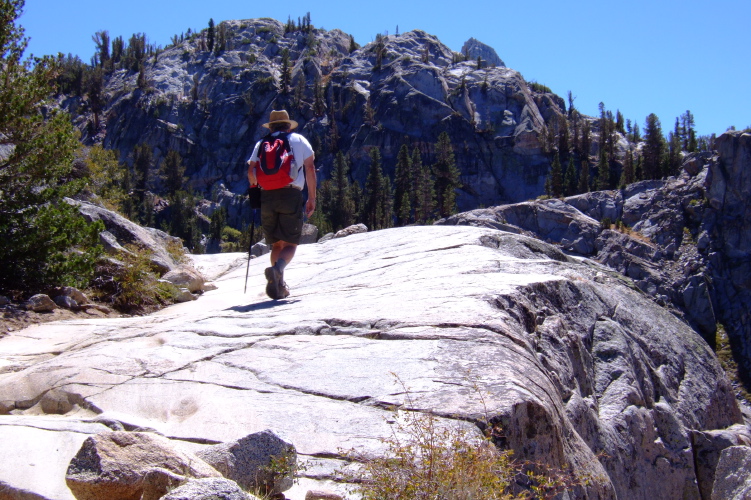 Ron climbs a slab on the trail.