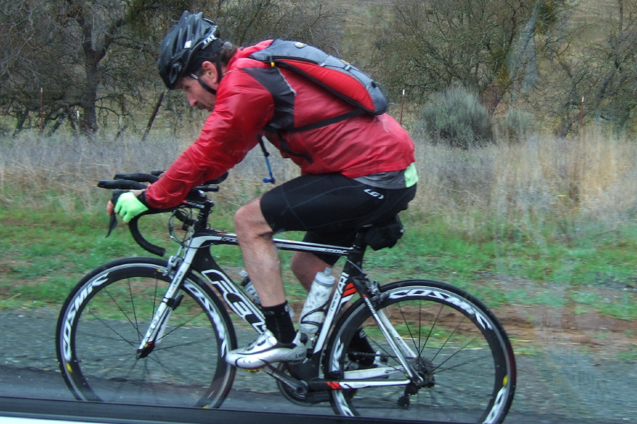 A wet rider presses on to the finish line.