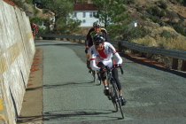 Vincent Chiu prepares to go hard on the last corner;  Bill Preucel is hot on his tail.