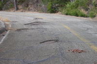 Mt. Umunhum Rd. potholes in a curve, downhill lane (3200ft)