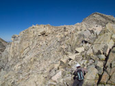 Bill and Stella climb over granite rubble toward the summit.  Photo courtesy of Frank Paysen.
