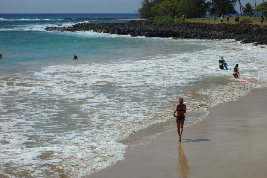 Laura runs toward the water at Brennecke Beach