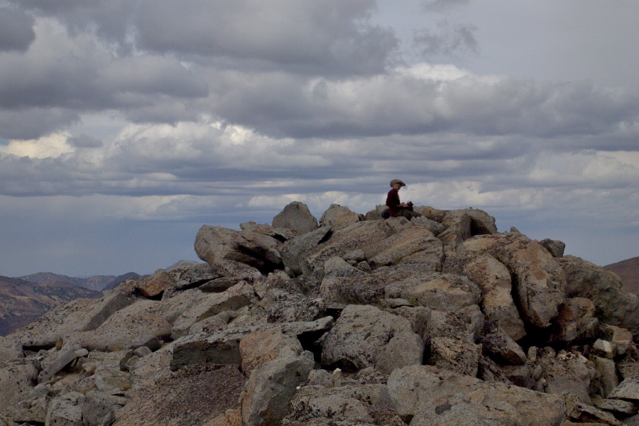 Bill sits atop Mammoth Peak (middle summit), making his radio calls.