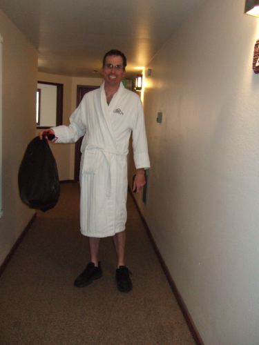 Bill carries out the garbage on his way to the spa.