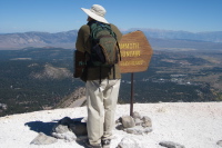 David rests on the summit sign.