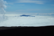 Hualala'i Volcano (8271ft) rises above the clouds above the Kona coast.